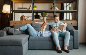 love-couple-resting-on-comfortable-couch-at-home-5R78BFY